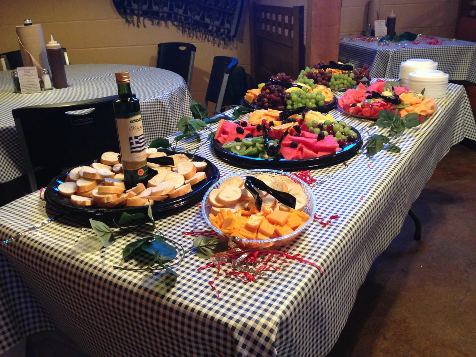 hors d'oeuvre spread with various fruits, bread, crackers and cheeses